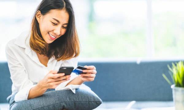 woman making online payment on her phone