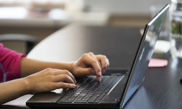 woman typing on laptop
