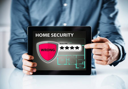 Person holding a tablet displaying a home security interface with a warning label that reads "WRONG" and a PIN entry field showing asterisks.