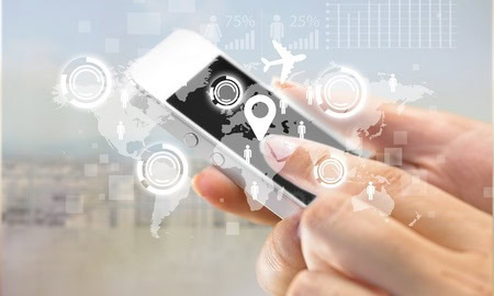 Person using a smartphone with digital icons and world map overlay, indicating global connectivity and GPS navigation.